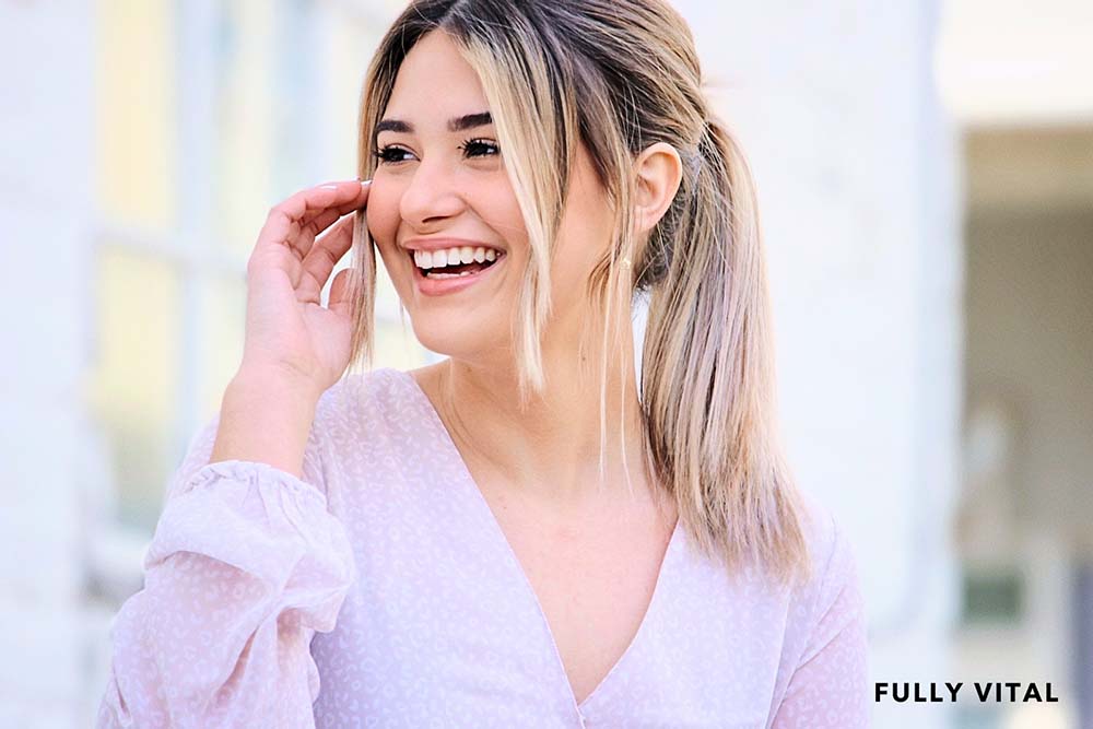 Smiling woman with ponytail with bangs