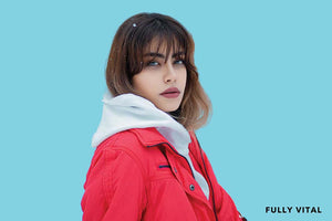 Woman in red jacket with hippie wispy bangs