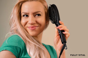 Woman styling hair with electric comb