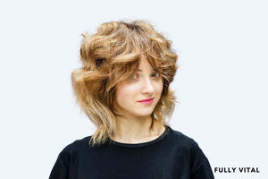 Woman in black with medium shag haircut