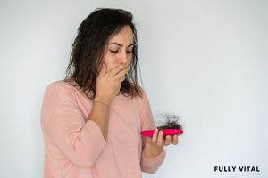 Woman suffering from postpartum alopecia